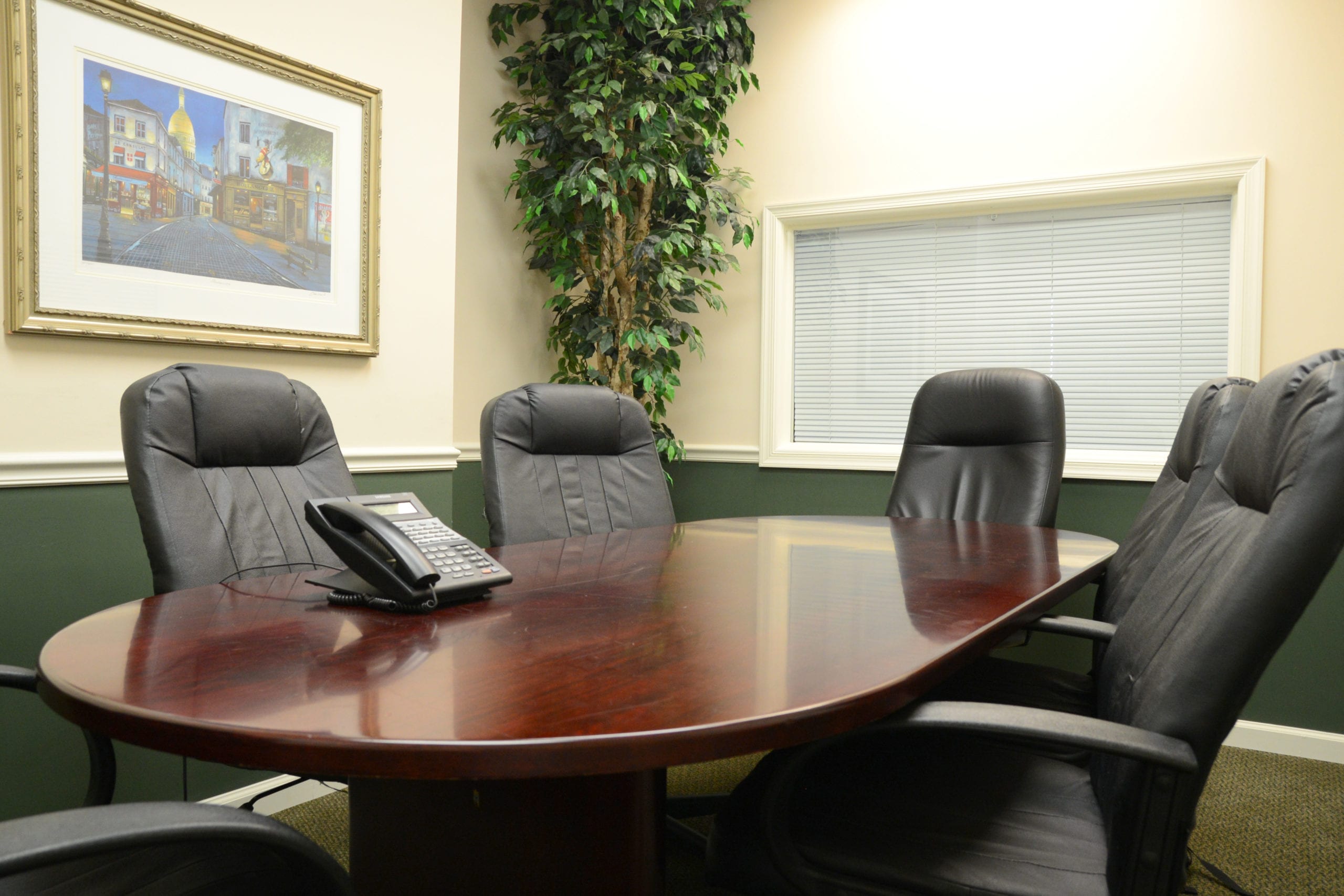 Professional discussing mortgage options with a couple in an office.