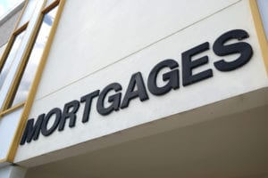 Building facade with a large 'MORTGAGES' sign