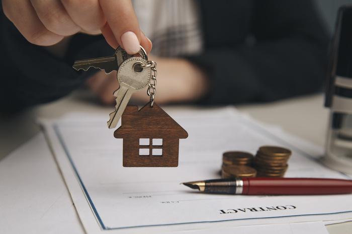 Mortgage lender giving home keys to client
