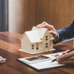 Homeowner discussing home mortgage and loan with agent