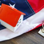 USA flag, house model and keys - VA loan concept